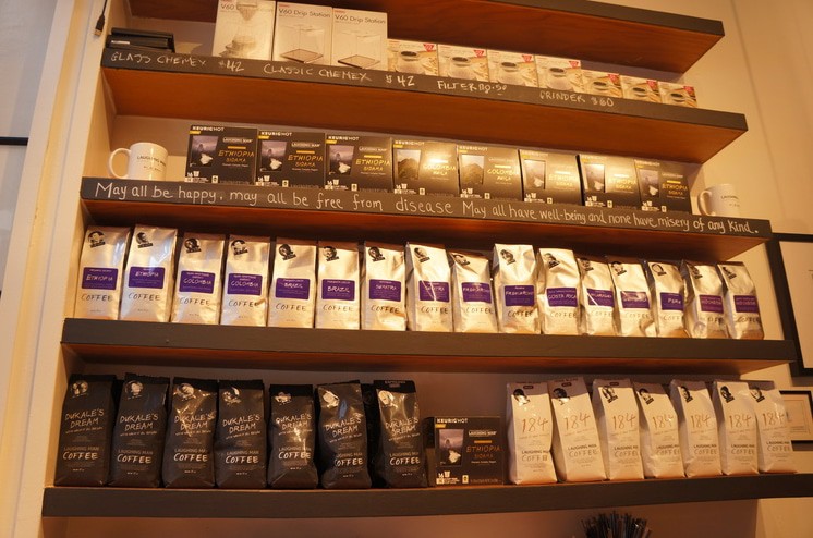 Bags of coffee beans on a shelf.