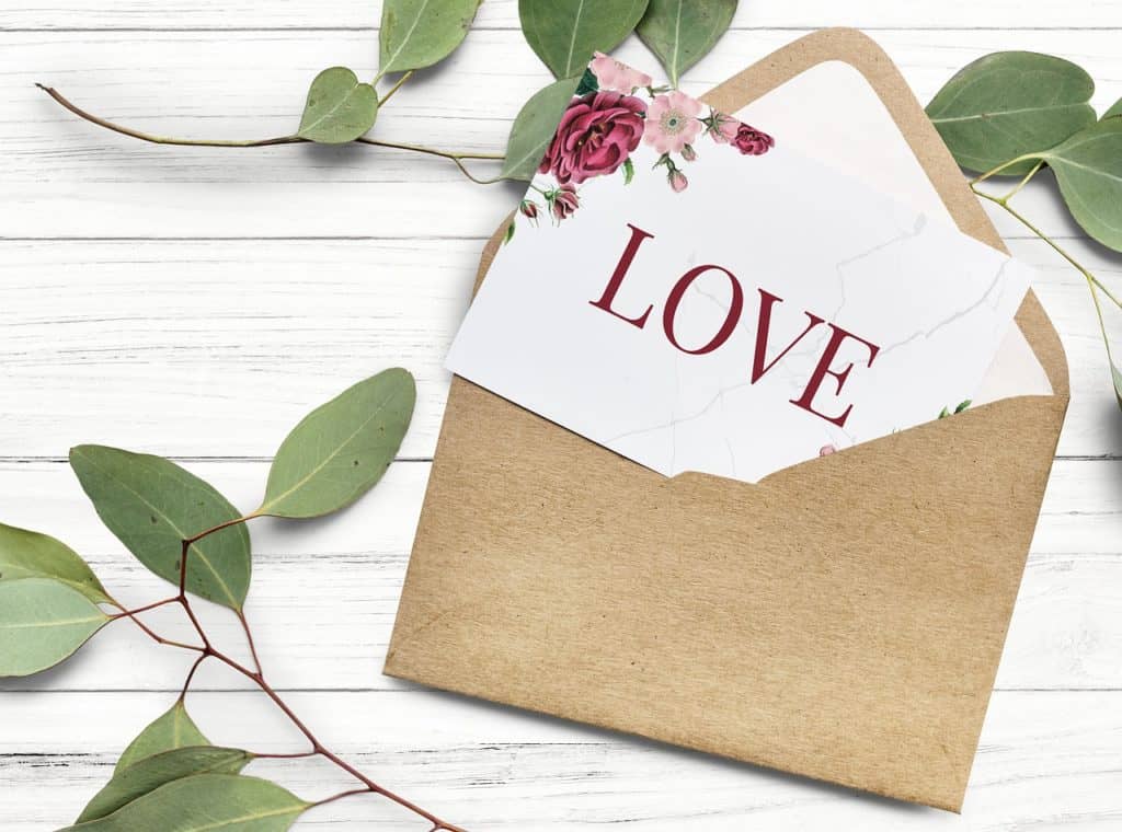 A white letter says Love in a brown envelope.