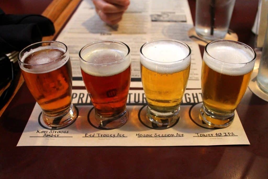 Close up of four small taster-size alcoholic beverages.