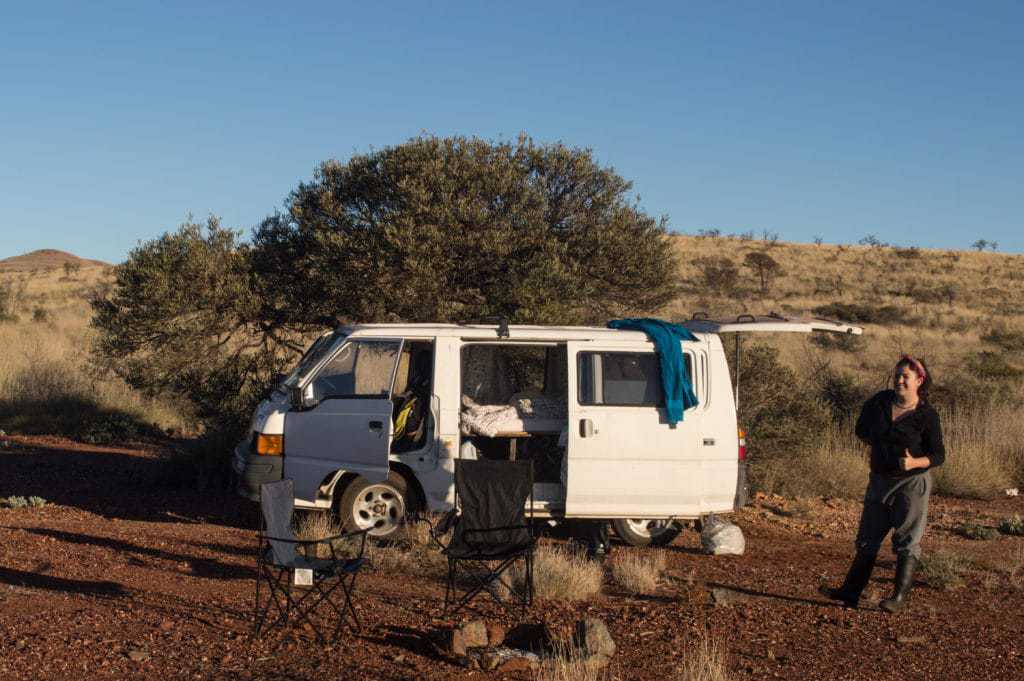 A campervan has all of its doors opened.