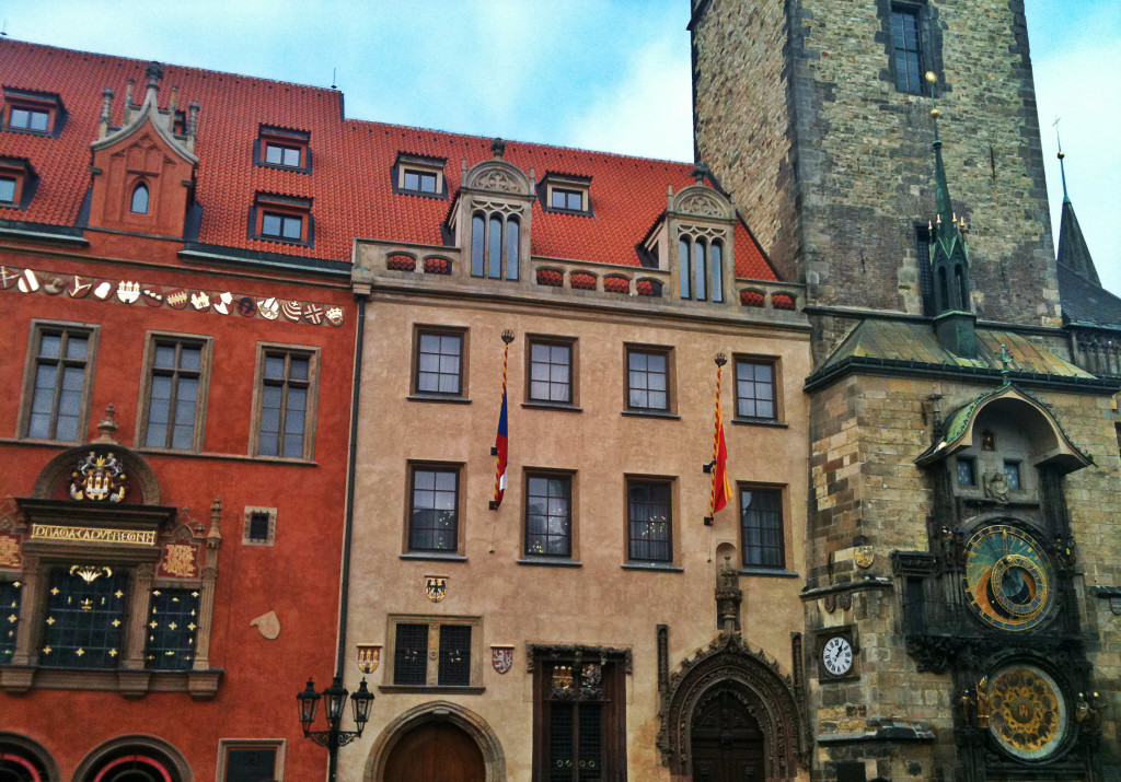 A large brick building with many windows and a red roof.