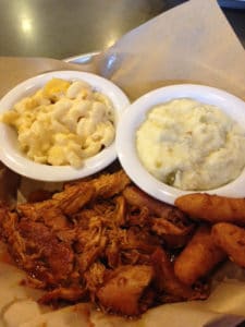 BBQ food next to mashed potatoes and mac and cheese.