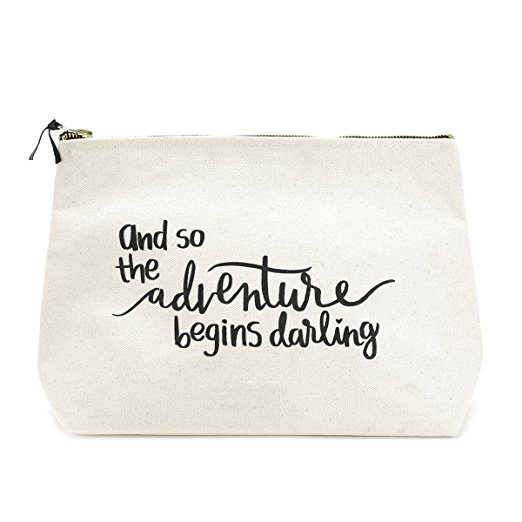 A white bag with black writing that says \"and so the adventure begins darling.\"