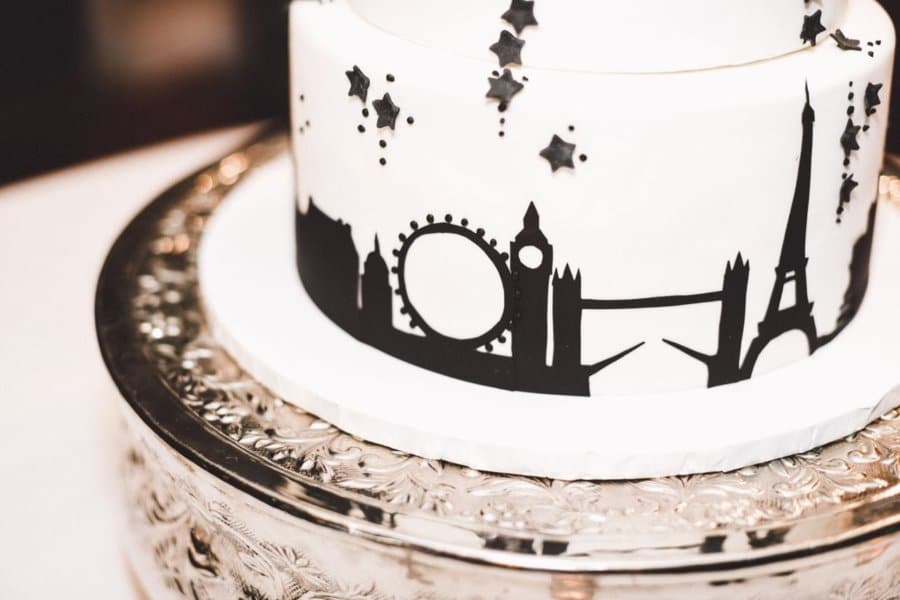 Close up of a white cake featuring a London silhouette in black.