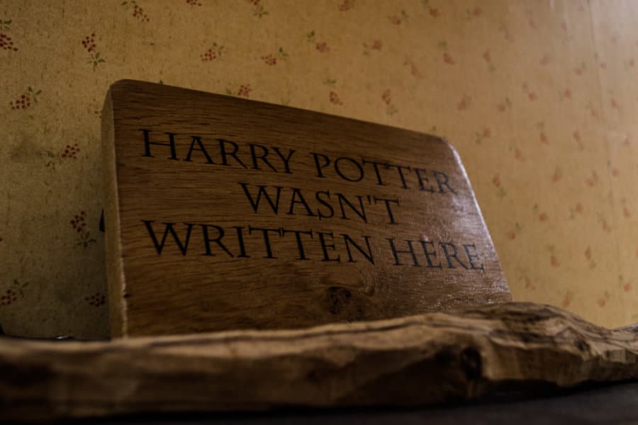 A wooden sign with black text that says Harry Potter wasn\'t written here.