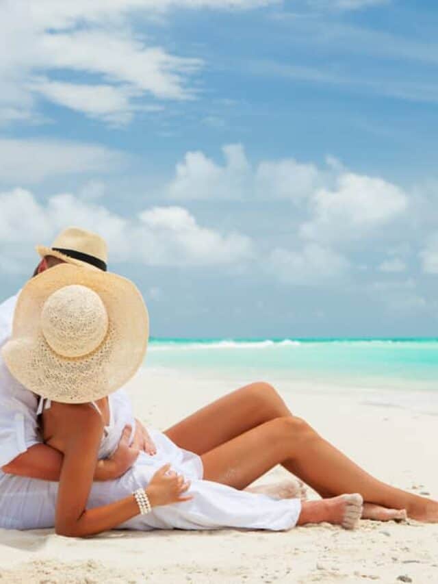 cropped-couple-sitting-on-beach-tropical-island-honeymoon-ocean-summer-shutterstock_151787042.jpg