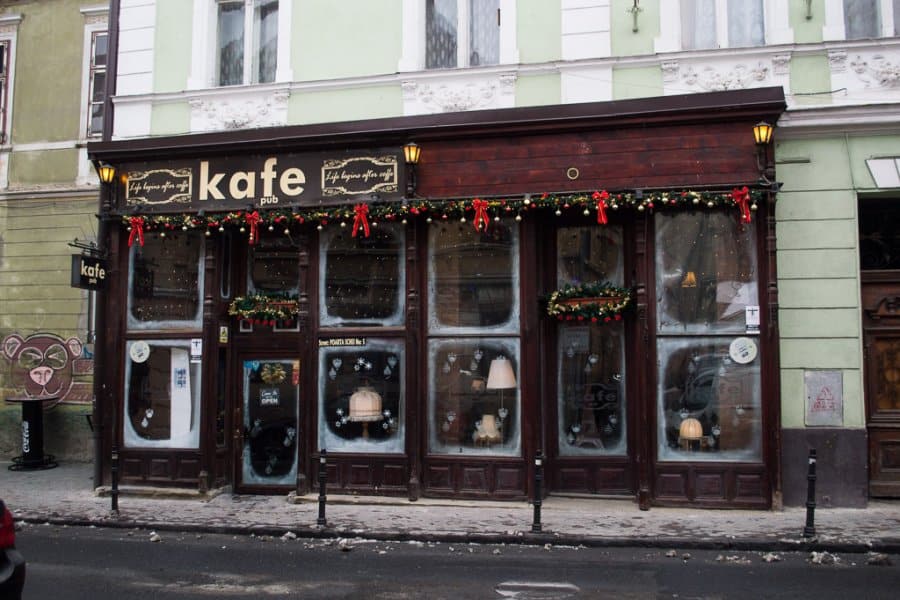 Outside of a wooden building that says kafe.