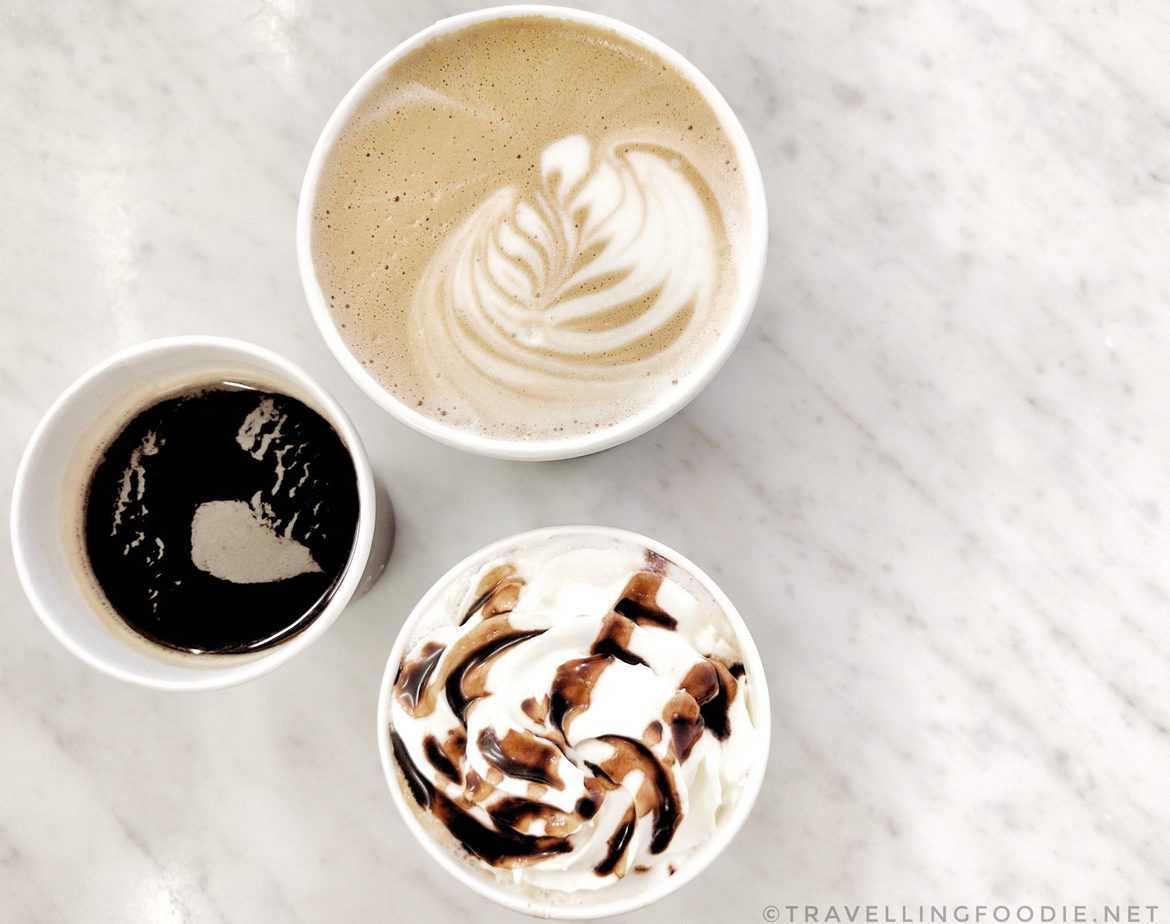 Aerial view of coffees on a white marble table.