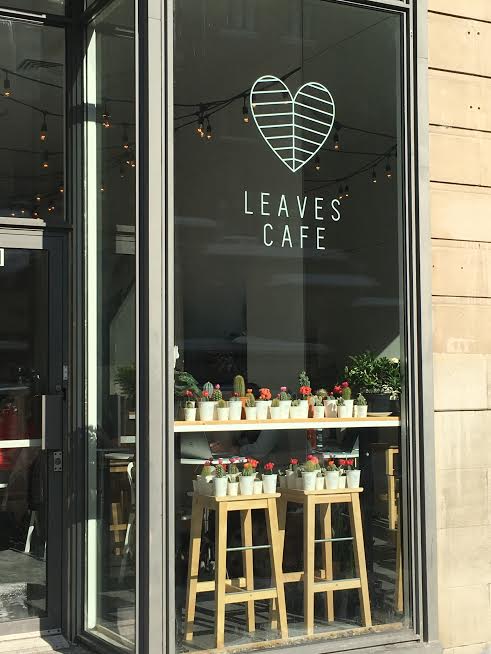 Exterior of a building that says "Leaves Cafe."