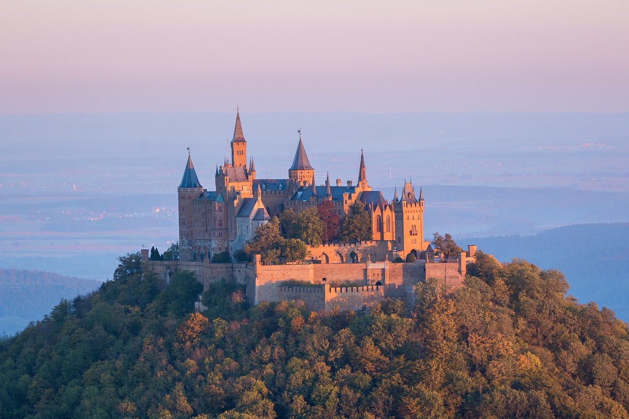 A big castle standing on top of a mountain surrounded by purple sky.