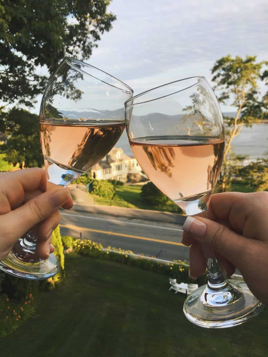 Two glasses of wine being toasted.