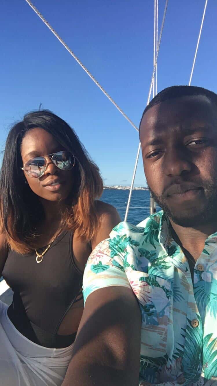 A couple poses while on a boat.