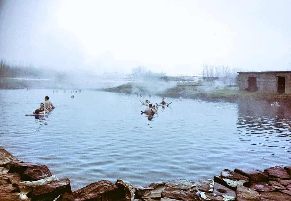 People are in a natural hot spring.