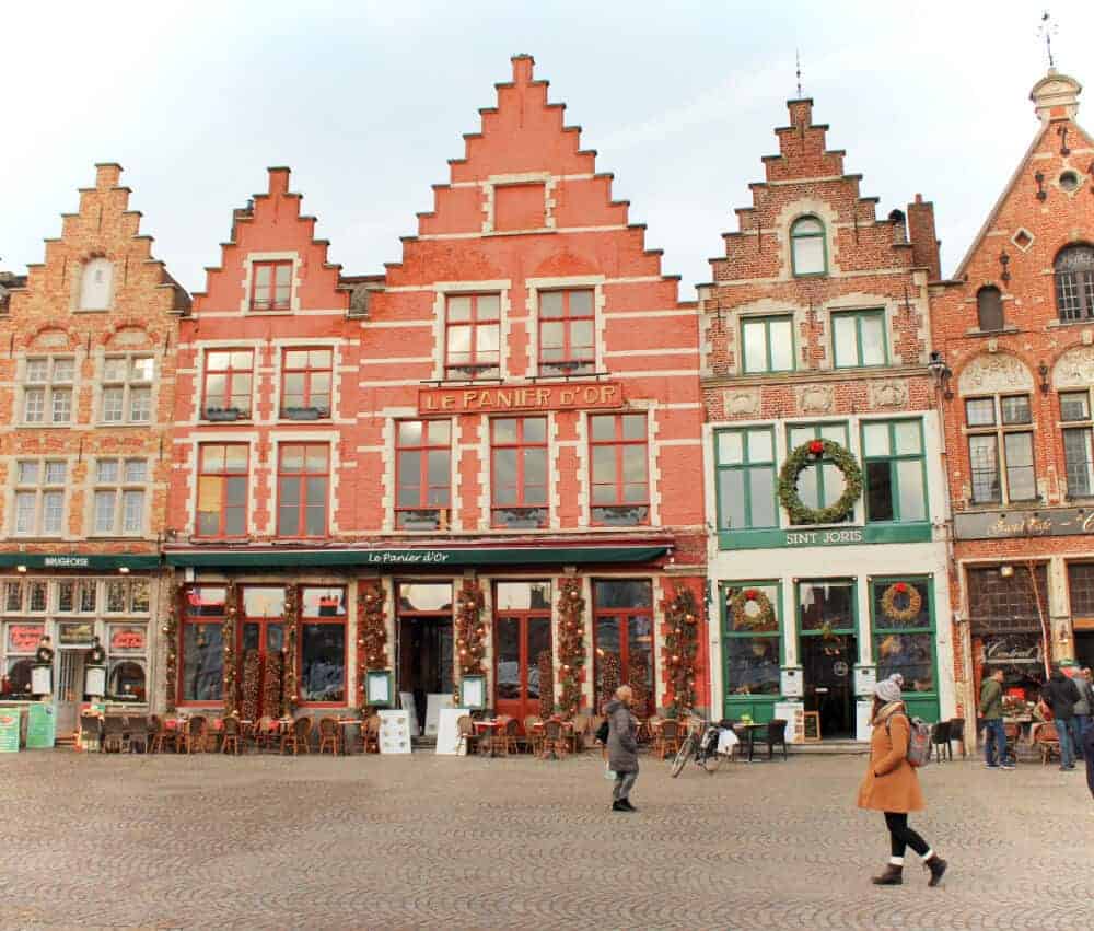 A row of cute buildings in Belgium decorated for Christmas in a romantic getaway spot