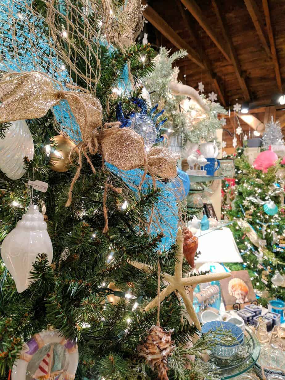 Close up of blue, gold, and white decorations on a Christmas tree.