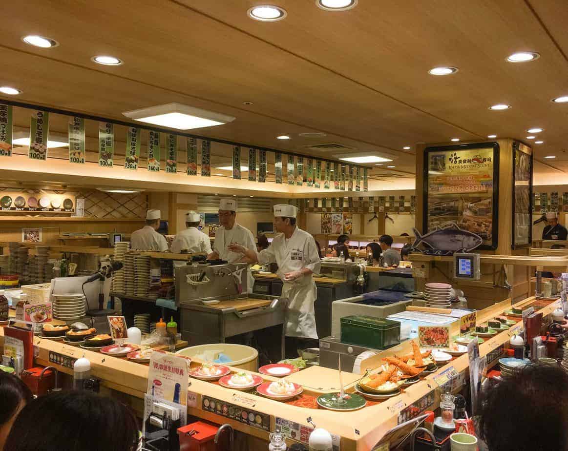People work inside a sushi restaurant.