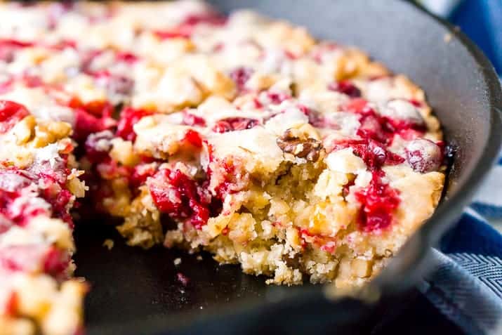 Close up of a dessert made with raspberries in a black skillet.