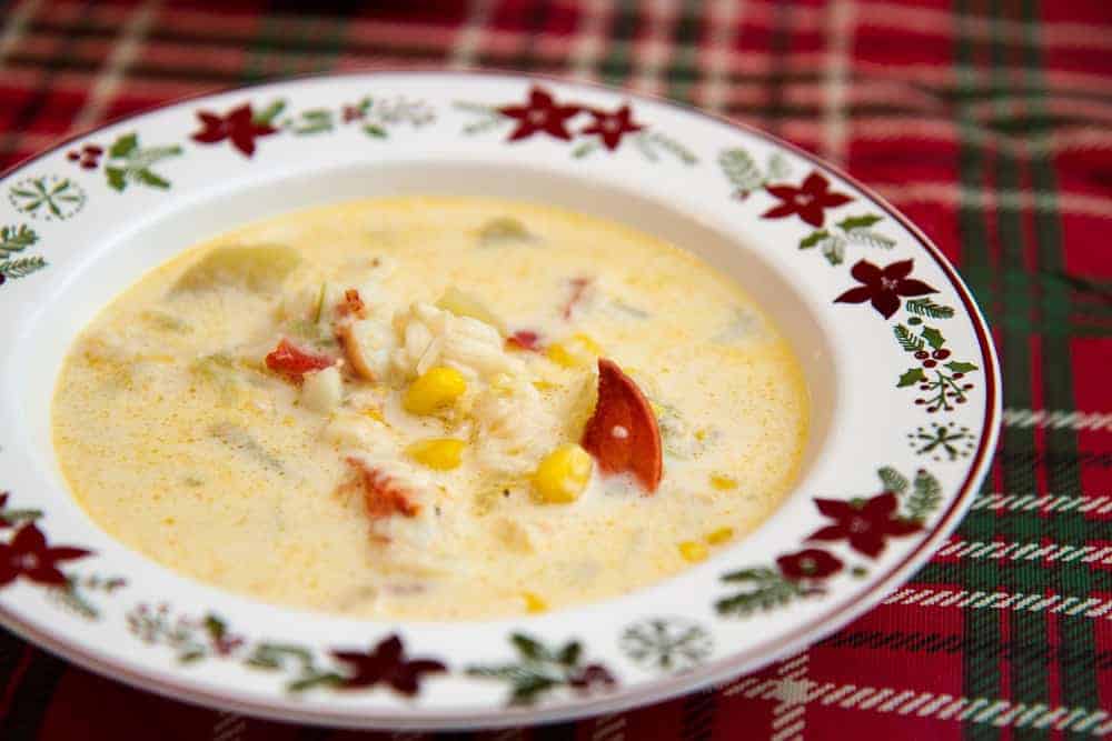Close up of seafood chowder in a holiday-themed bowl.