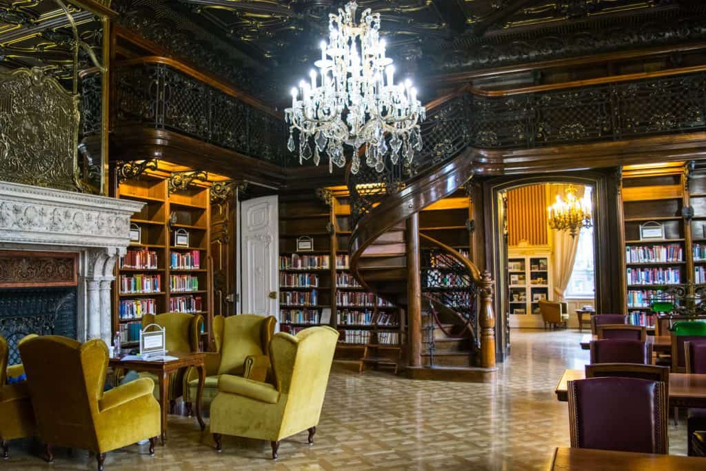 a beautiful and cozy library with chandelier - one of the romantic things to do in Budapest, Hungary