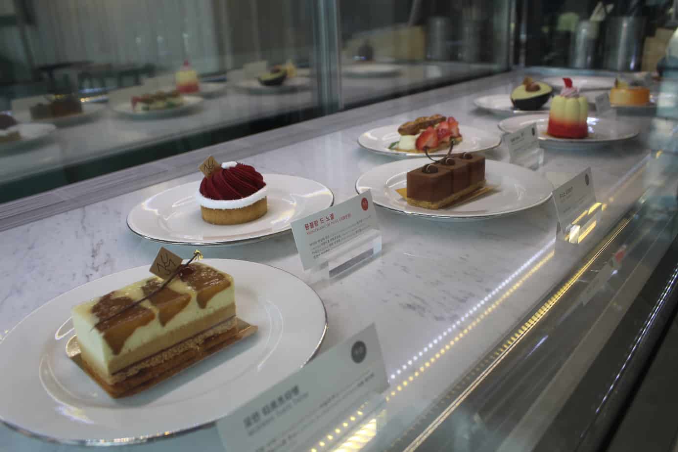 Close up of pastries behind a glass plate.