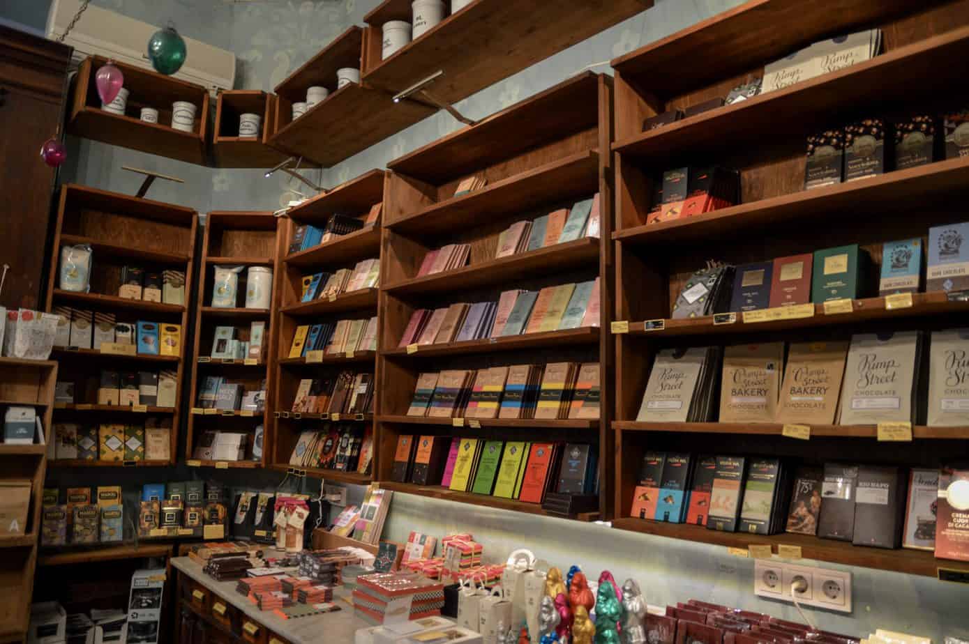 A book shelf filled with books inside a shop.