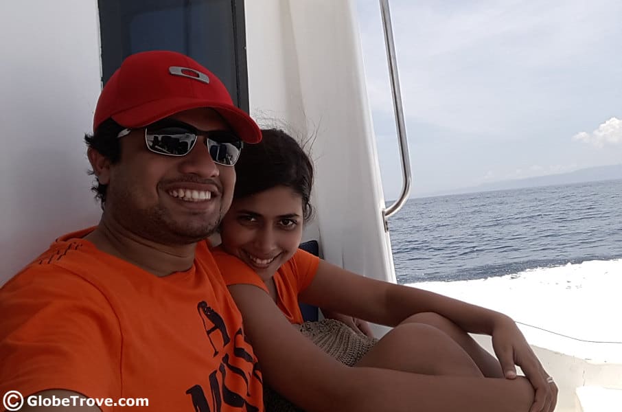 A couple sitting on a boat smiling.