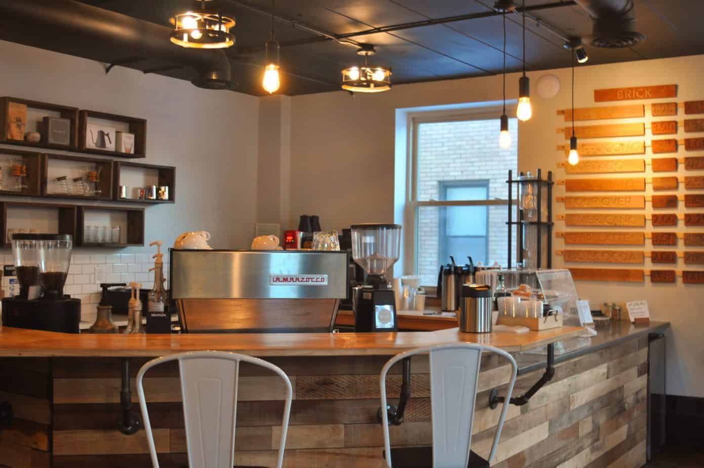 Chairs are set up next to a counter filled with coffee machines.