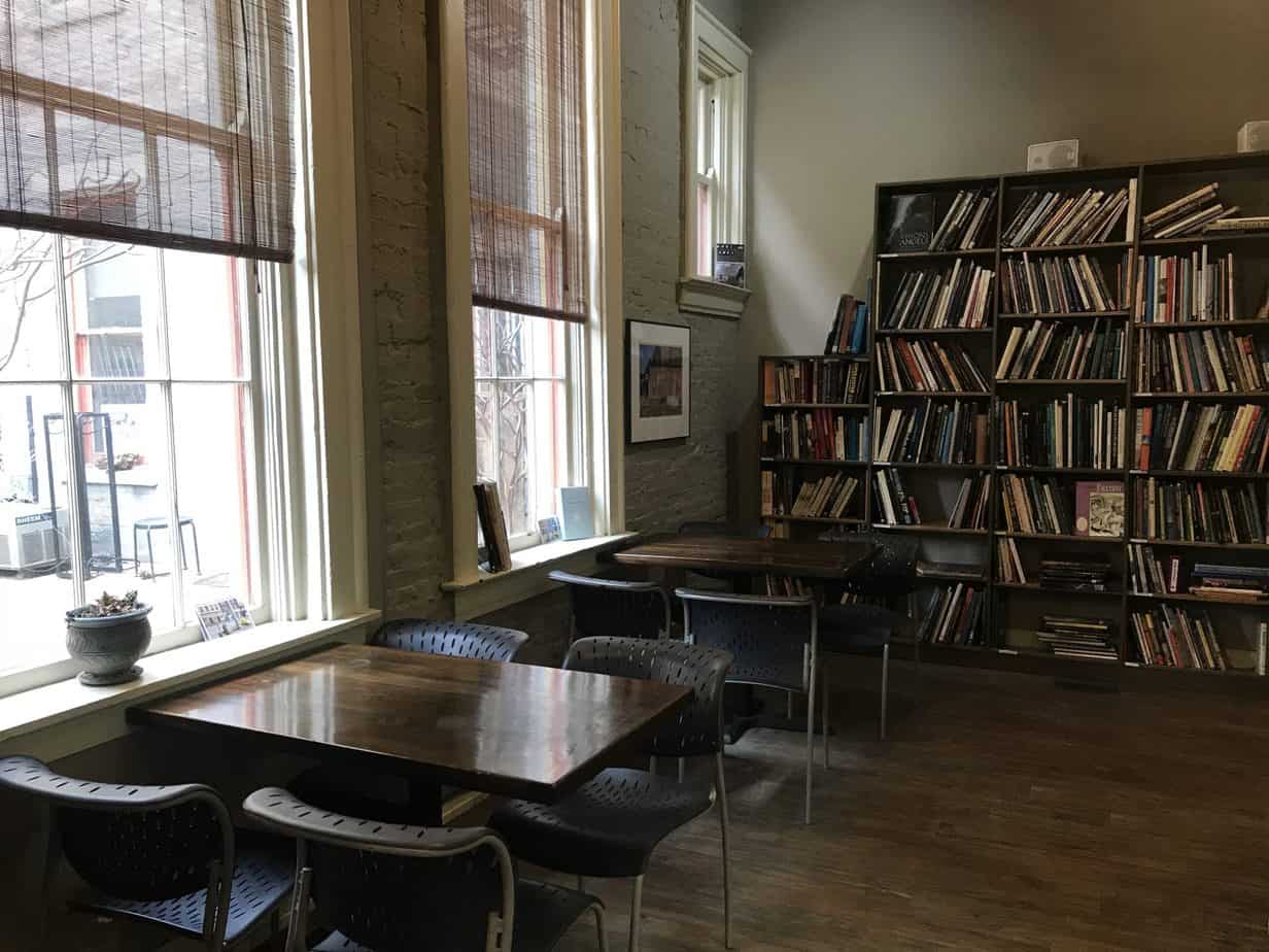 Empty tables with chairs around them.