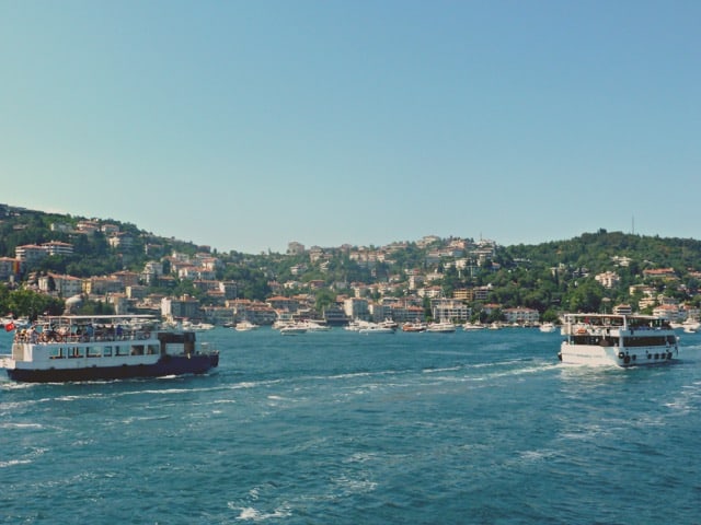 Boats on the blue ocean under a blue sky.