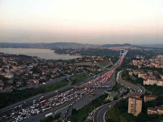 Cars create traffic on a highway next to the water.