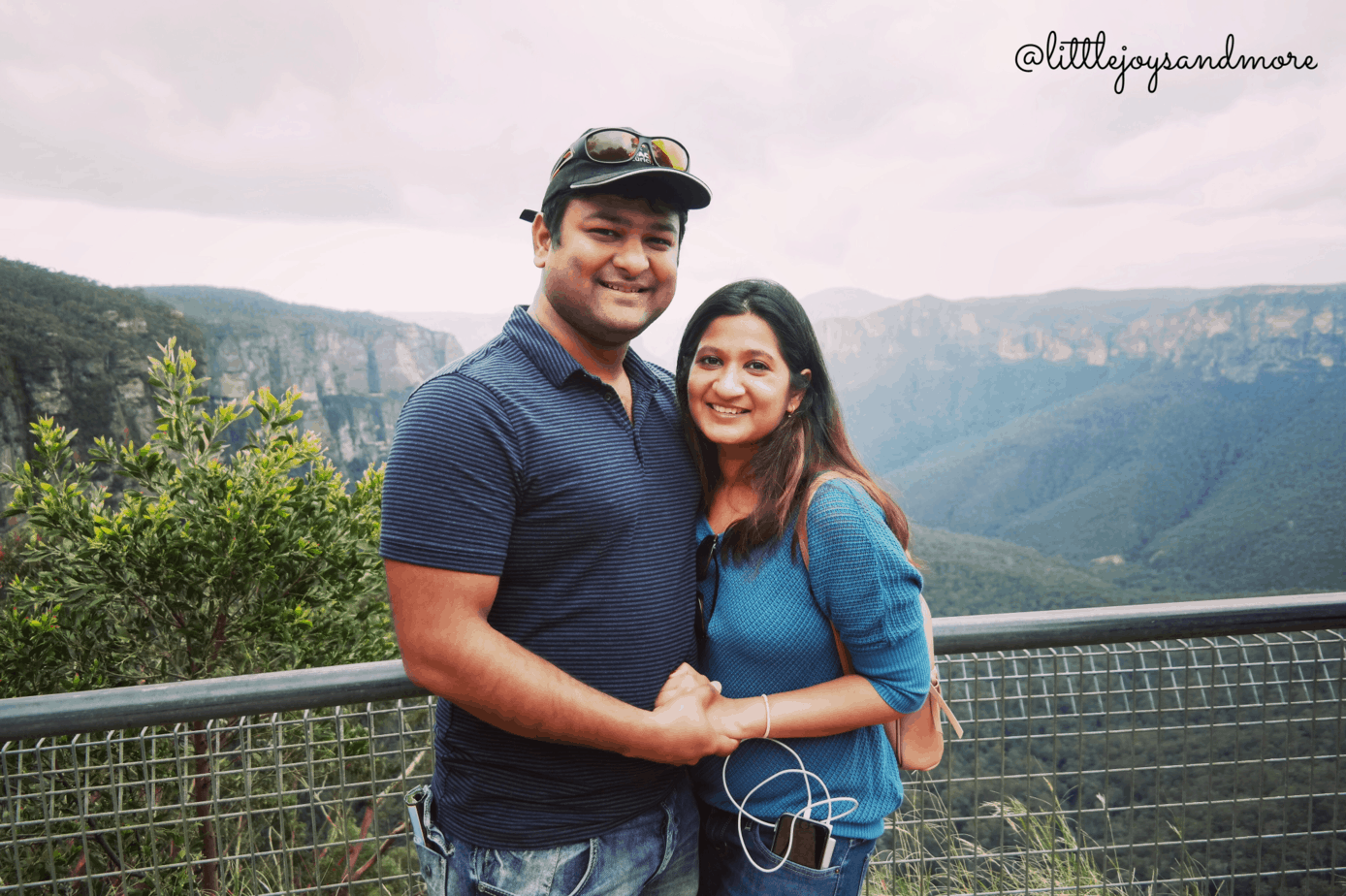 A couple smiles with a canyon behind them