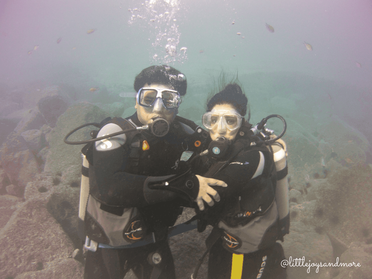 Man and woman scuba diving under water.