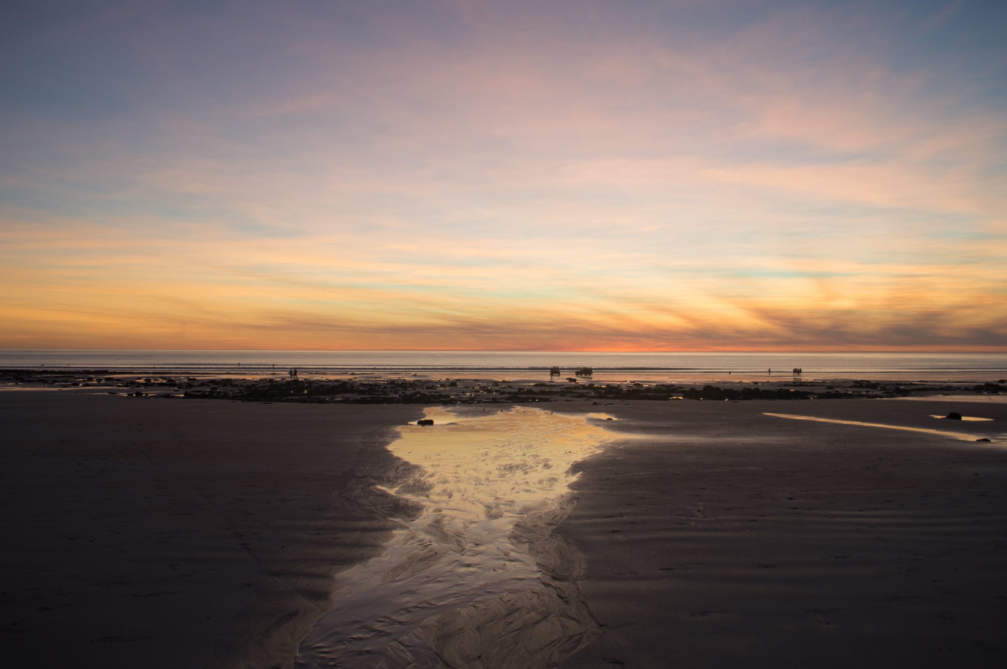 A calm beach at sunset.