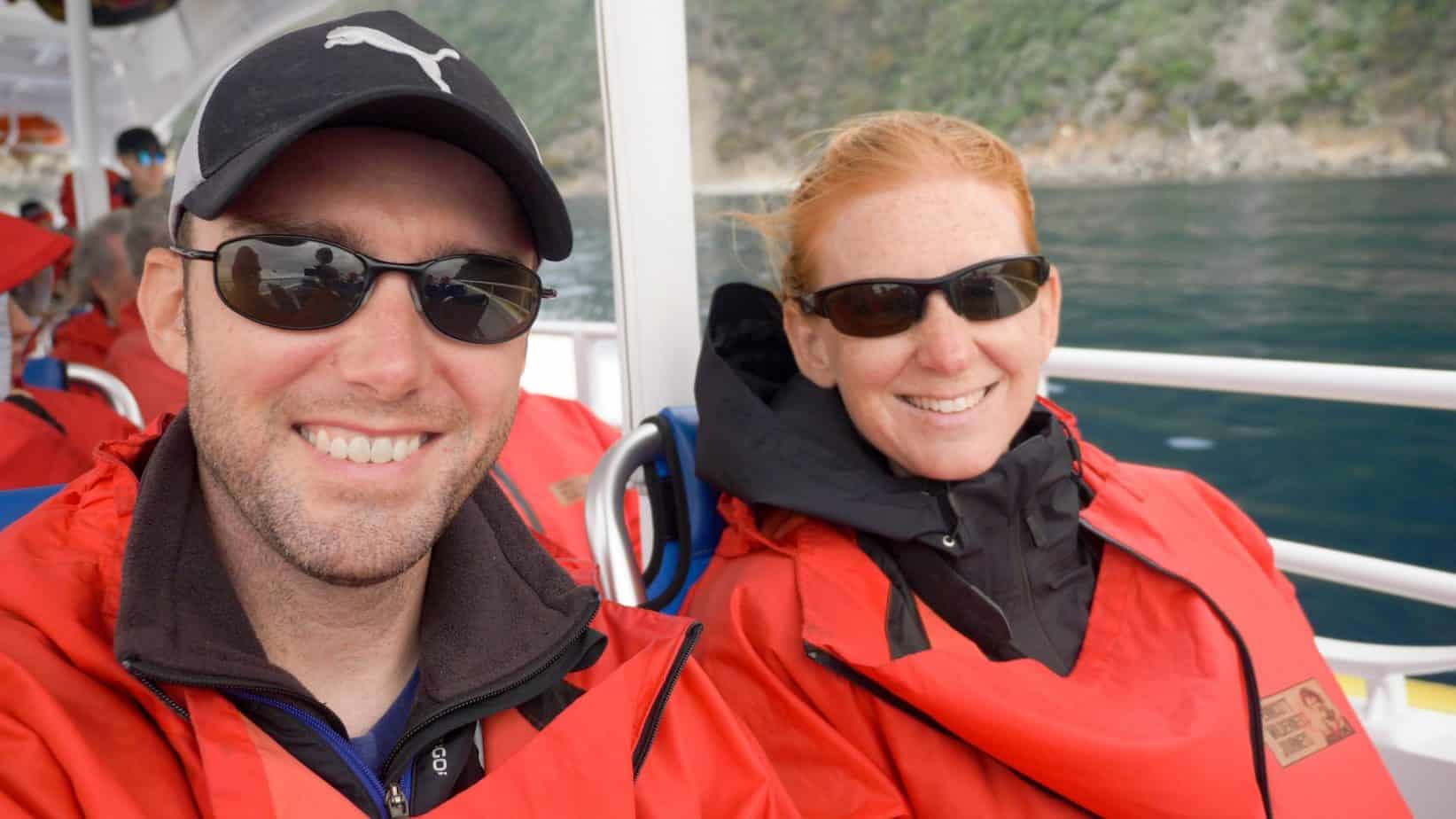 A man wearing sunglasses taking a selfie on a boat