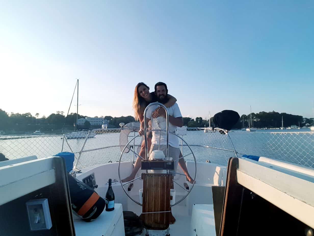 A couple smiles on a boat.