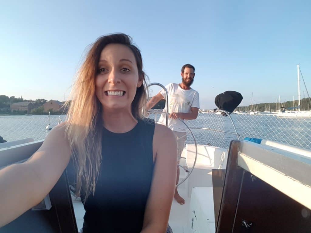 A couple smiles on a boat.