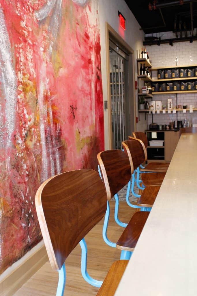 Brown wooden chairs next to a table in a cafe.