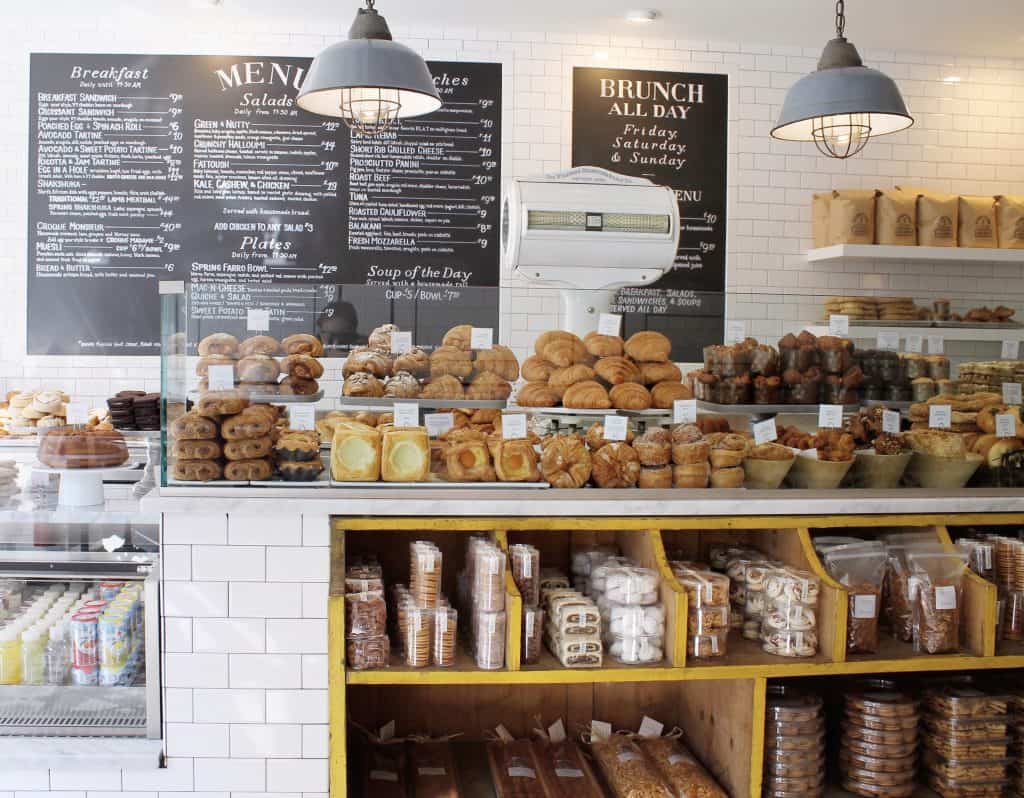 A counter filled with pastries.