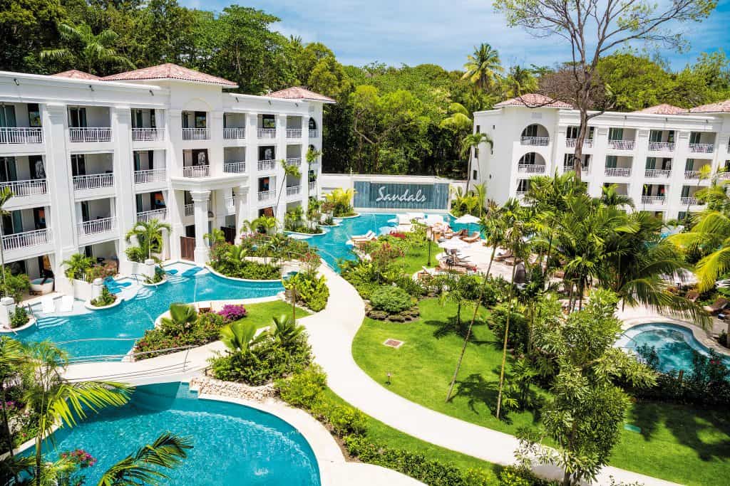 Sandals all inclusive luxury resort is seen with beautiful pools and lush vegetation