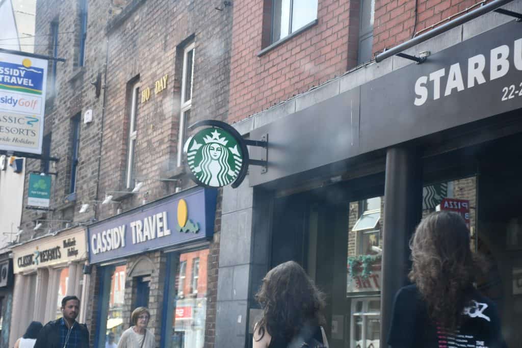 People walk around a Starbucks.