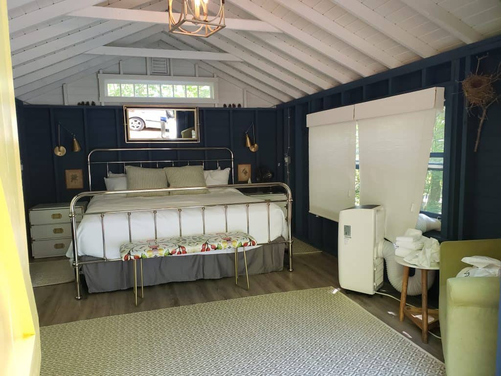 romantic glamping in maine - queen bed inside cabin