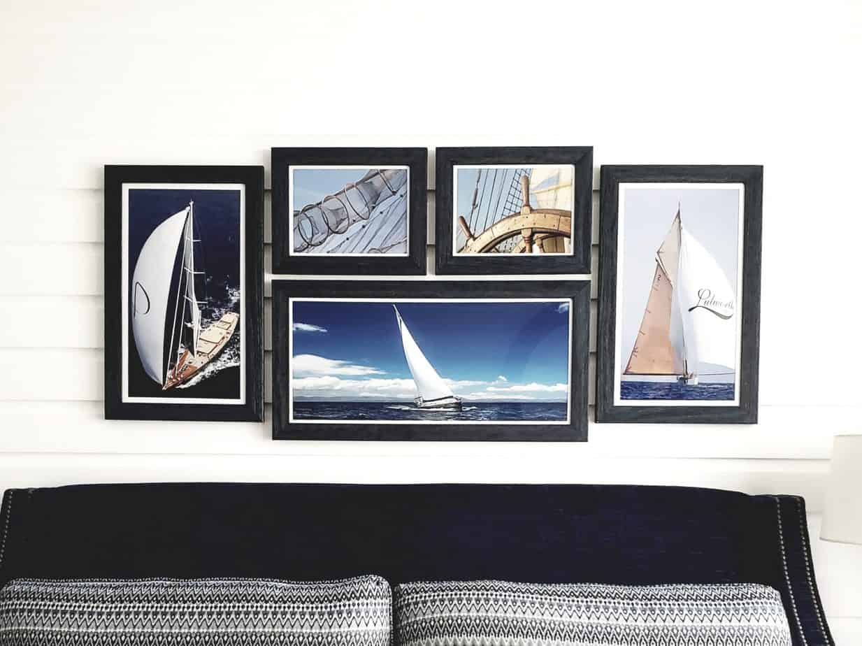 A wall with five black wooden frames.