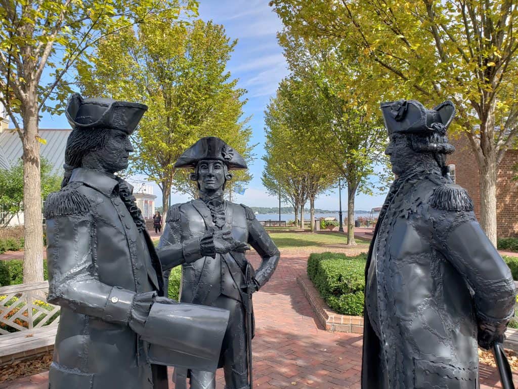 Statues of historic figures in the middle of a park