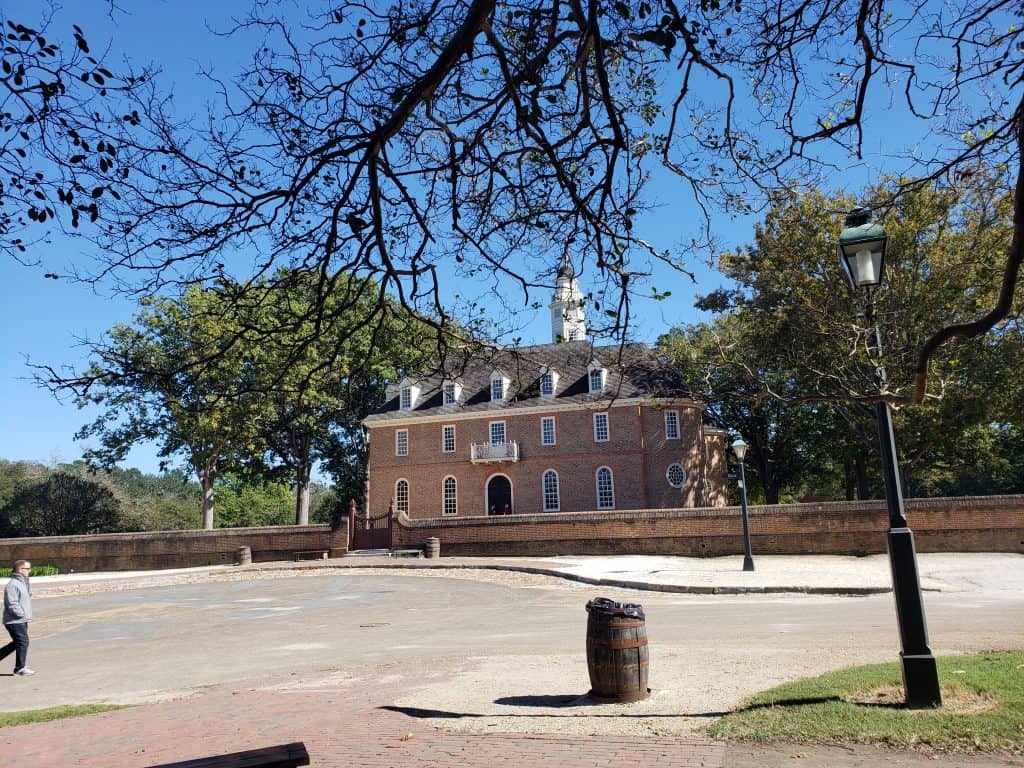 A historic brick building stands tall next to an empty square.