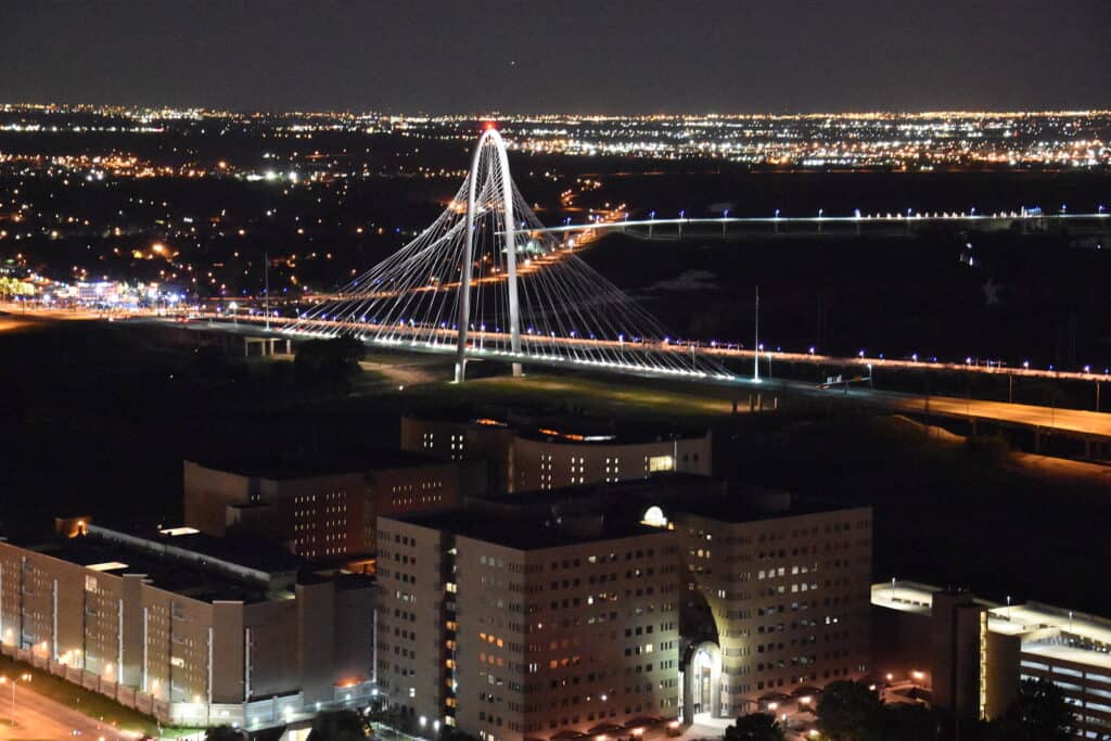 View of a bridge stretching over the water at night.