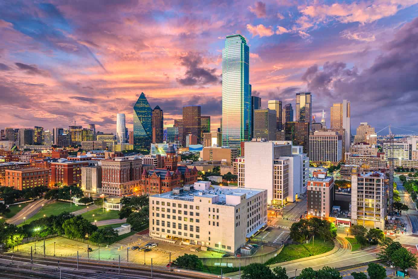 City skyline under a purple and blue sky.