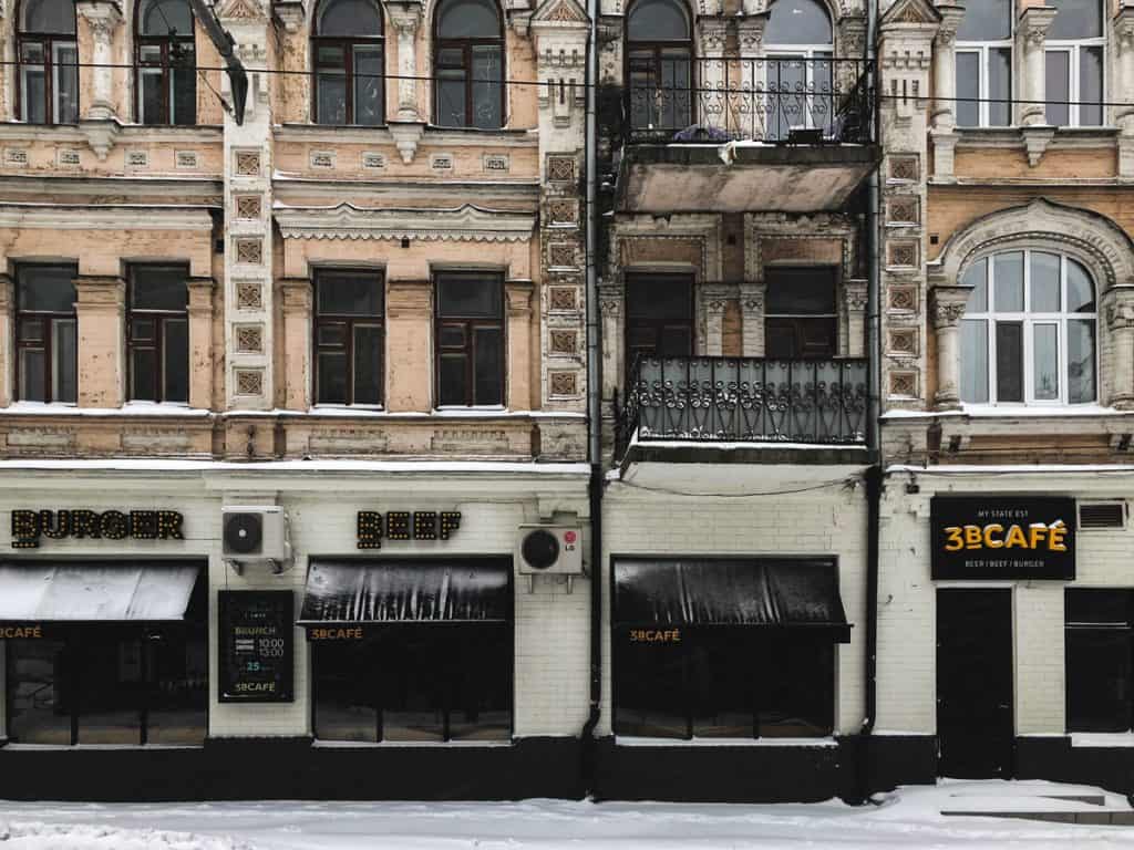 Photo of brick storefronts in a snowy city.