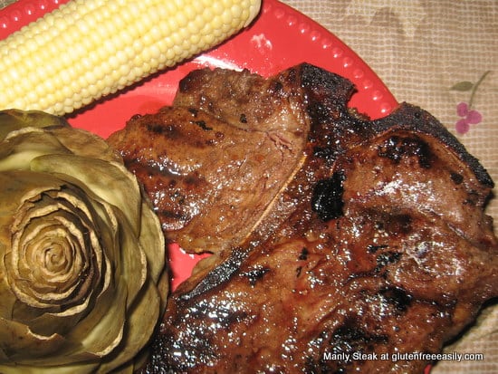 Close up of steak and corn on a red plate.