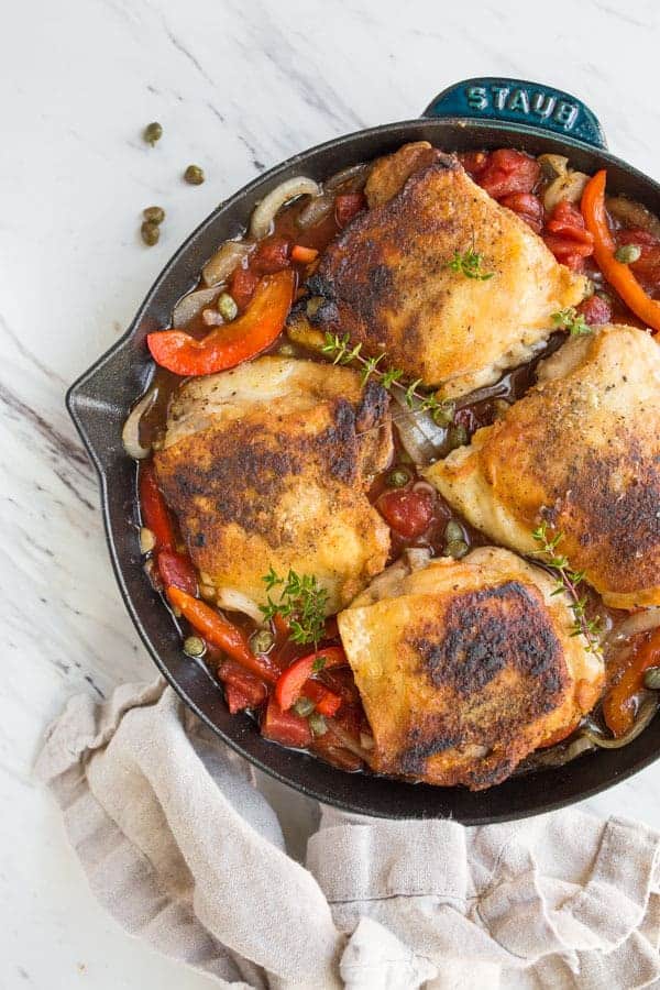 View of meat and veggies in a skillet.