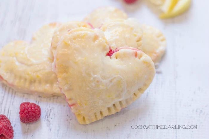 A heart-shaped cookie filled with something red.